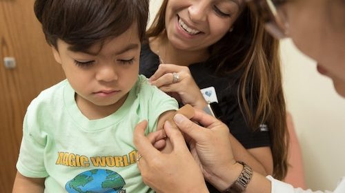 A young patient receives a flu vaccination in a doctor's office