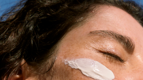 Woman with sun cream smudge on her face