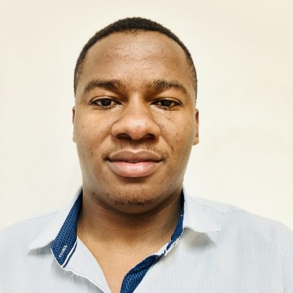 Prosper Chapanduka smiles at the camera, wearing a shirt