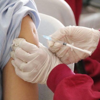 adult vaccinations - doctor or nurse wearing gloves giving intramuscular injection