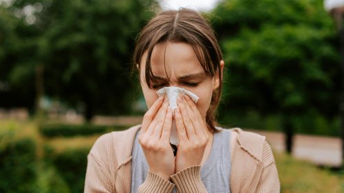 Cold vs Flu vs RSV: woman with respiratory symptoms